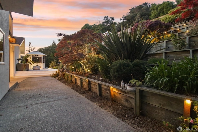 view of side of property with fence and a gazebo