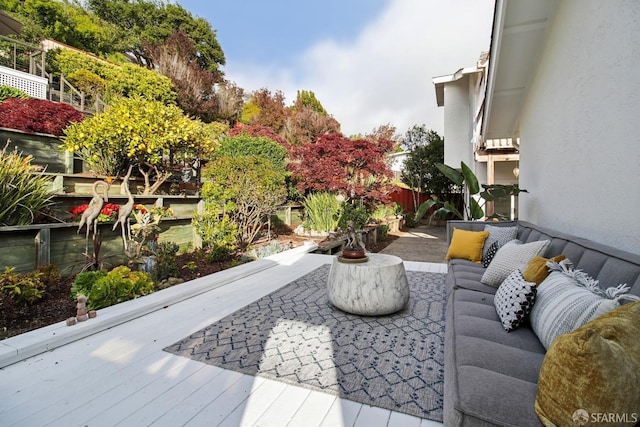 view of patio / terrace with a wooden deck and fence