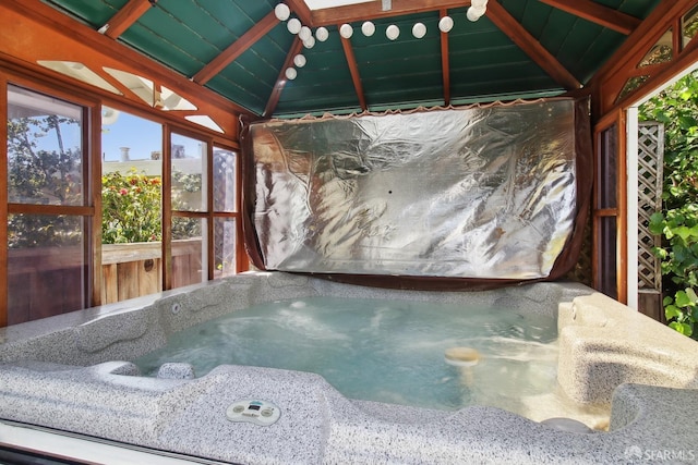 misc room with a jacuzzi, vaulted ceiling, and wood ceiling