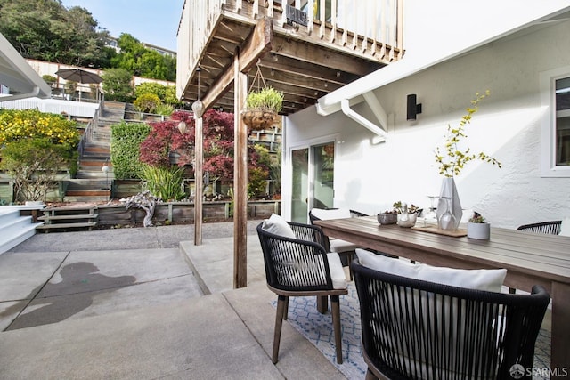 view of patio / terrace featuring stairway and outdoor dining space