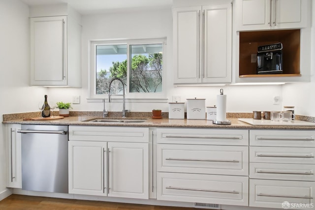 bar featuring stainless steel dishwasher and a sink
