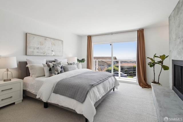 bedroom featuring light carpet and access to exterior