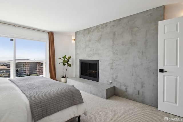 bedroom featuring carpet and a fireplace