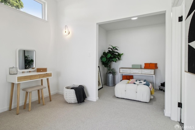 sitting room featuring baseboards and carpet
