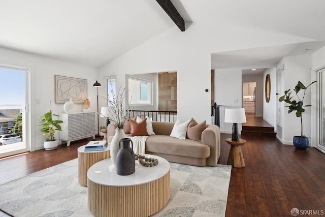 living area with wood-type flooring, a wealth of natural light, beam ceiling, and baseboards