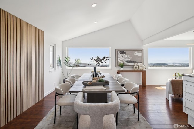 dining room with baseboards, vaulted ceiling, wood finished floors, and recessed lighting