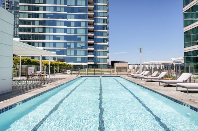 pool featuring fence and a patio area
