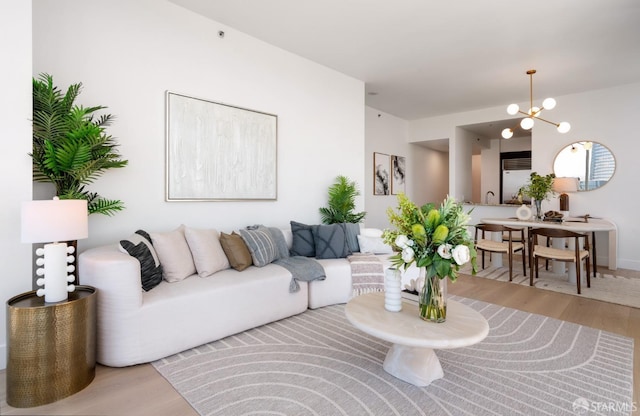 living room featuring an inviting chandelier and wood finished floors