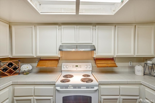 503 Camelback Rd, Pleasant Hill, CA 94523 - kitchen with under cabinet range hood, white range with electric cooktop, white cabinets, and light countertops