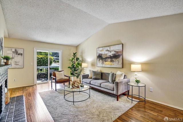 503 Camelback Rd, Pleasant Hill, CA 94523 - living area featuring a brick fireplace, a textured ceiling, wood finished floors, baseboards, and vaulted ceiling