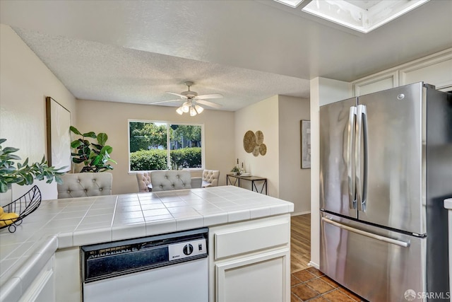 503 Camelback Rd, Pleasant Hill, CA 94523 - kitchen with freestanding refrigerator, tile countertops, ceiling fan, dishwasher, and a textured ceiling