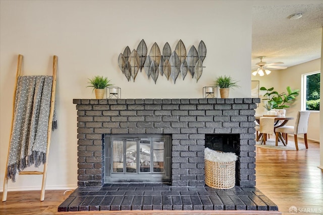 503 Camelback Rd, Pleasant Hill, CA 94523 - detailed view of a fireplace, wood finished floors, ceiling fan, a smoke detector, and a textured ceiling