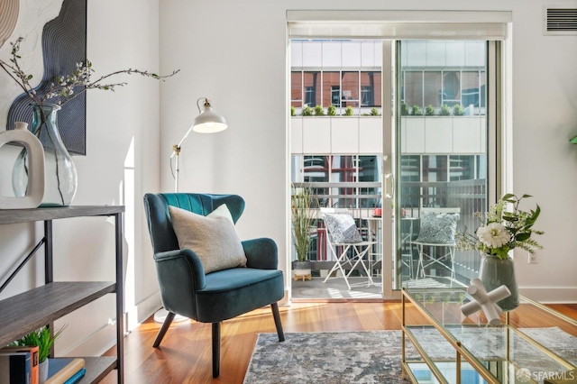 sitting room with hardwood / wood-style flooring