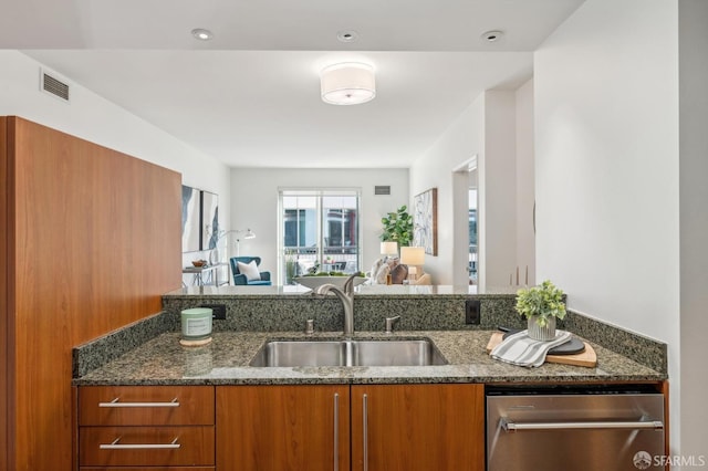 50 Lansing St Unit 403, San Francisco, CA 94105 - kitchen featuring brown cabinetry, a sink, dark stone countertops, and open floor plan
