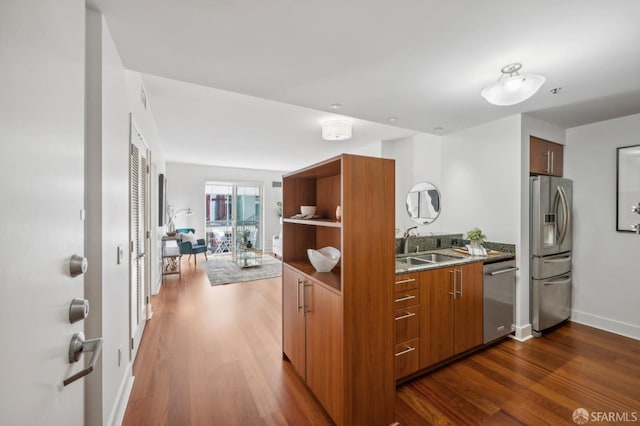 kitchen featuring dark hardwood / wood-style flooring, appliances with stainless steel finishes, and sink