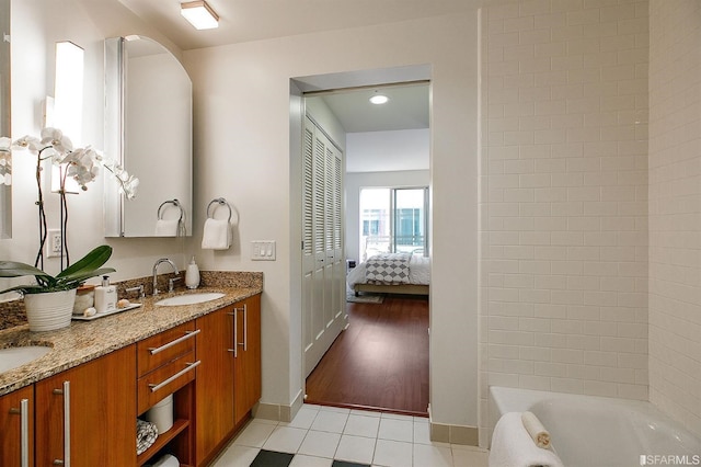 bathroom featuring a bathtub, vanity, and wood-type flooring