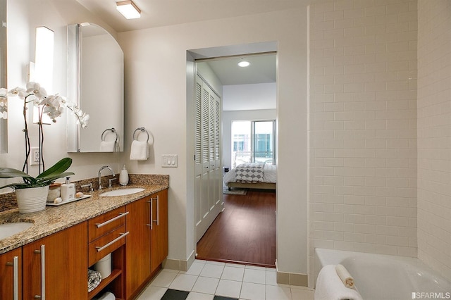 50 Lansing St Unit 403, San Francisco, CA 94105 - bathroom featuring baseboards, tile patterned flooring, double vanity, and ensuite bath