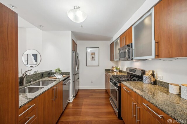 50 Lansing St Unit 403, San Francisco, CA 94105 - kitchen featuring stainless steel appliances, a sink, baseboards, dark wood finished floors, and glass insert cabinets