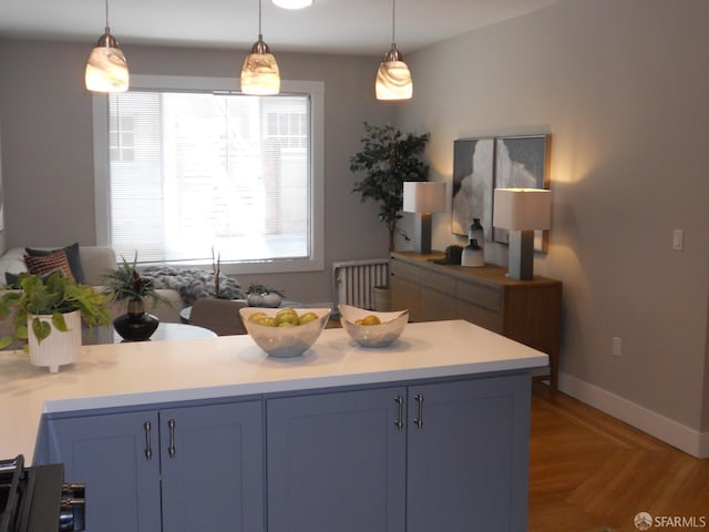 700 12th Ave Unit 2, San Francisco, CA 94118 - kitchen with blue cabinetry, light countertops, pendant lighting, and a peninsula