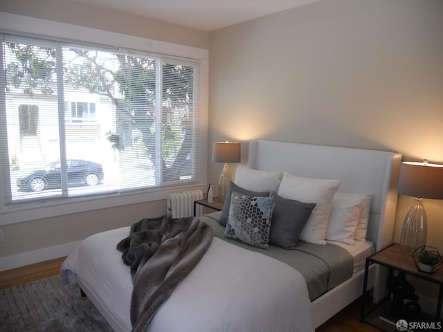 700 12th Ave Unit 2, San Francisco, CA 94118 - bedroom featuring radiator heating unit, wood finished floors, and multiple windows