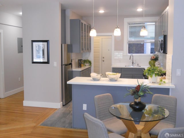 700 12th Ave Unit 2, San Francisco, CA 94118 - kitchen with appliances with stainless steel finishes, gray cabinetry, tasteful backsplash, and recessed lighting