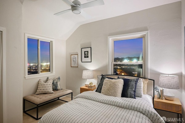 bedroom featuring a ceiling fan and lofted ceiling