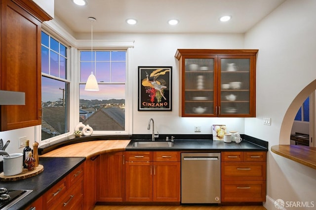 bar featuring recessed lighting, a sink, hanging light fixtures, dishwasher, and black stovetop