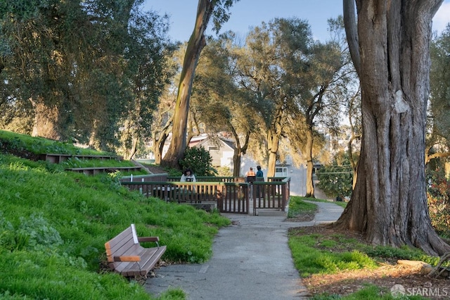 view of home's community featuring fence