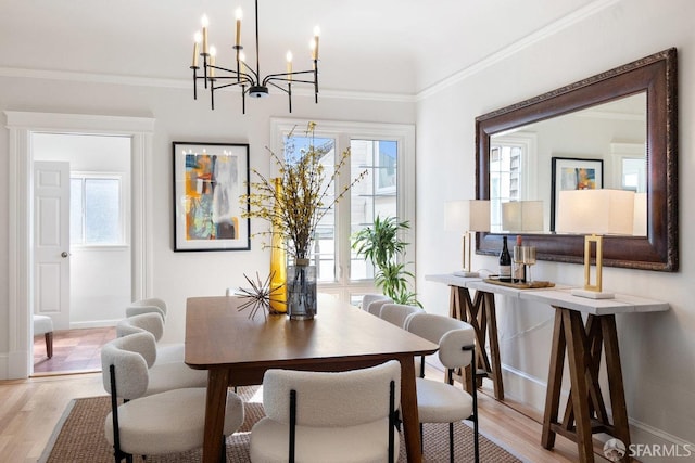 dining room featuring a wealth of natural light, light wood finished floors, and crown molding