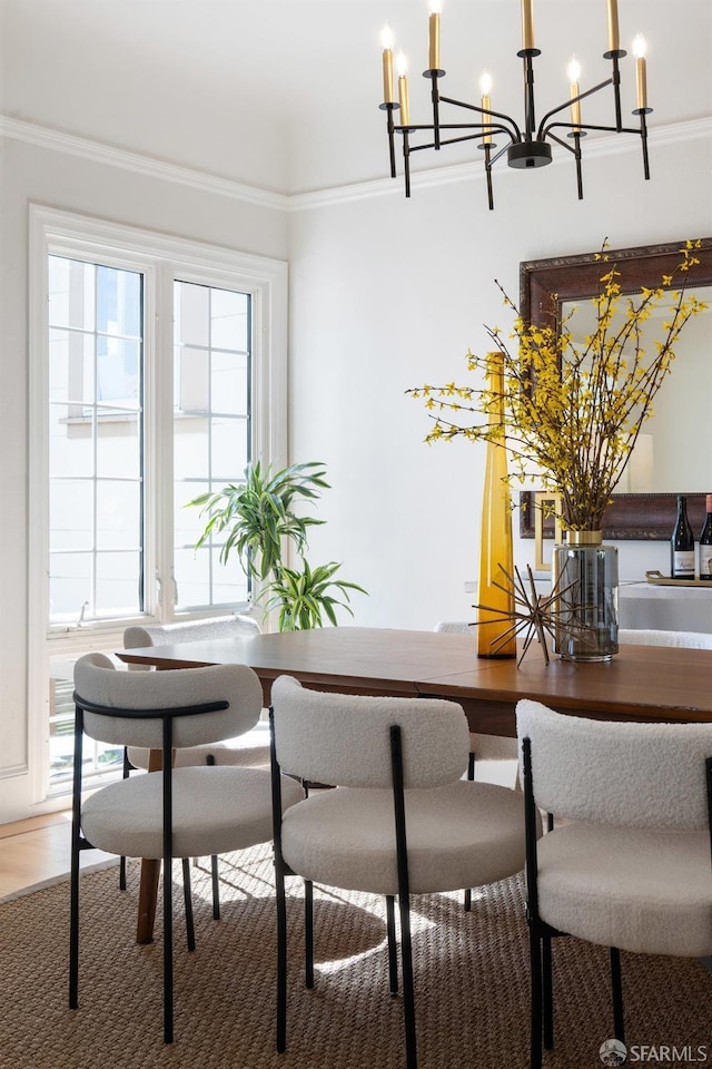 dining area with ornamental molding and wood finished floors