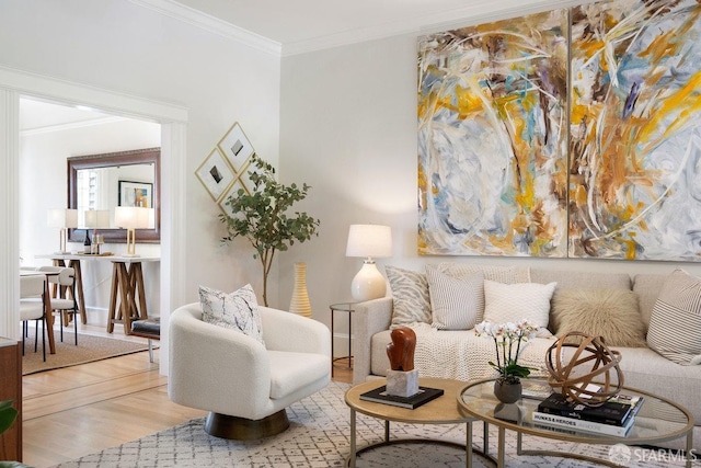 sitting room featuring ornamental molding and wood finished floors