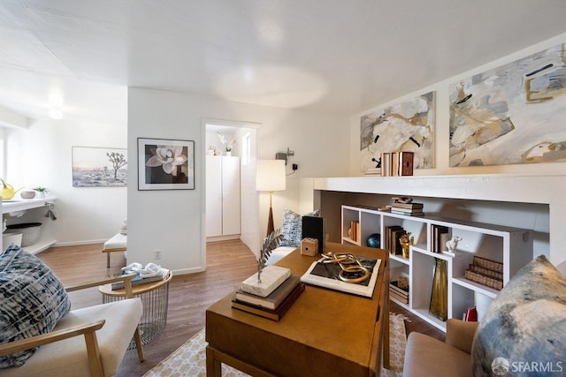 living room featuring baseboards and wood finished floors