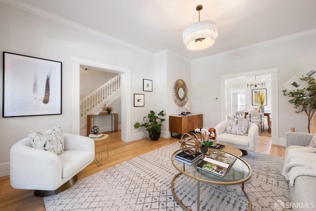 living area with ornamental molding, stairway, baseboards, and wood finished floors