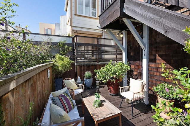 wooden deck with an outdoor living space