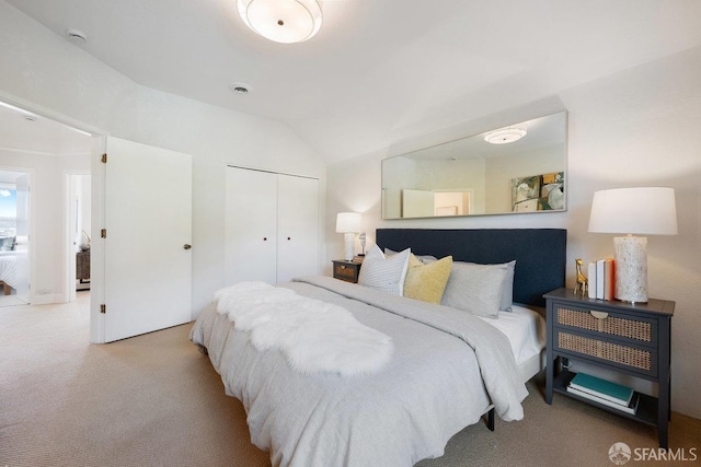 bedroom featuring lofted ceiling, carpet floors, a closet, and visible vents