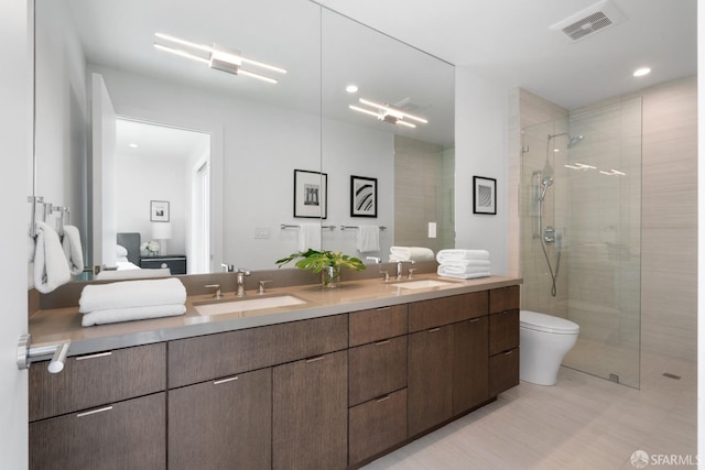 bathroom with vanity, toilet, and an enclosed shower