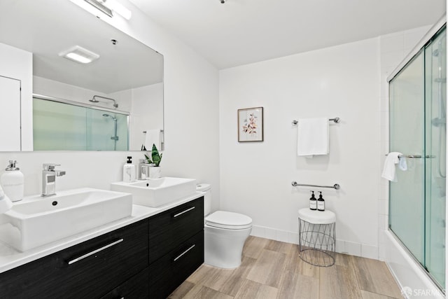 250 King St Unit 536, San Francisco, CA 94107 - bathroom with wood finished floors, double vanity, and enclosed tub / shower combo