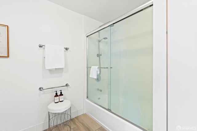 250 King St Unit 536, San Francisco, CA 94107 - full bathroom featuring enclosed tub / shower combo and wood finished floors