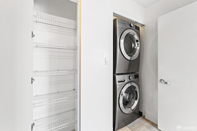 250 King St Unit 536, San Francisco, CA 94107 - laundry room featuring stacked washing machine and dryer and light wood-style flooring