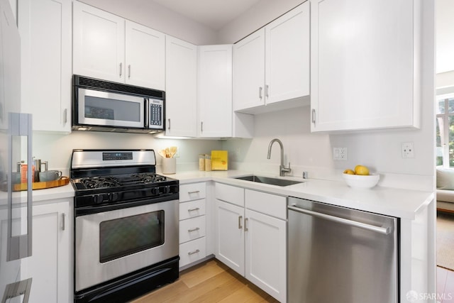 1829 15th St Unit 1, San Francisco, CA 94103 - kitchen with white cabinets, light countertops, a sink, and appliances with stainless steel finishes