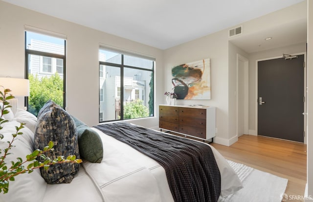1829 15th St Unit 1, San Francisco, CA 94103 - bedroom with light wood-type flooring, visible vents, and baseboards