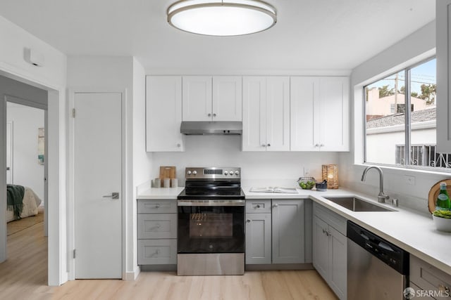 281 Polaris Way, Daly City, CA 94014 - kitchen featuring appliances with stainless steel finishes, gray cabinets, under cabinet range hood, light wood-style flooring, and plenty of natural light