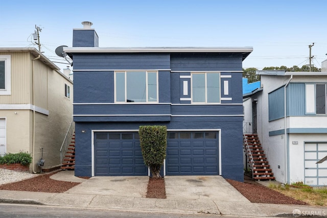 281 Polaris Way, Daly City, CA 94014 - view of front of house with stairway, concrete driveway, a garage, and stucco siding