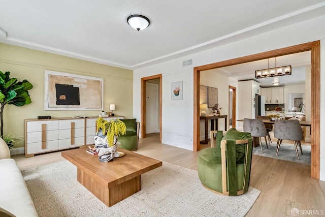 1210 40th Ave, San Francisco, CA 94122 - living room with light wood-style floors and a chandelier