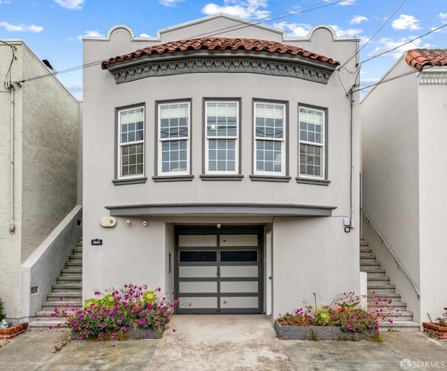 1210 40th Ave, San Francisco, CA 94122 - view of front of property featuring stairs, stucco siding, a garage, and a tiled roof