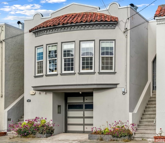 1210 40th Ave, San Francisco, CA 94122 - view of front of home with stairs, stucco siding, a garage, and a tile roof