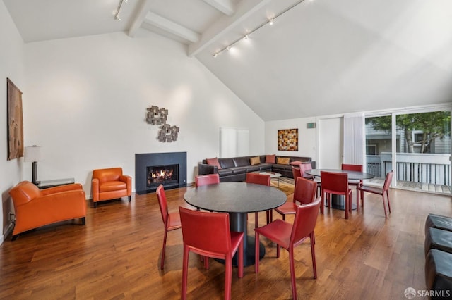 620 Clarendon Ave, San Francisco, CA 94131 - dining area featuring track lighting, vaulted ceiling with beams, a warm lit fireplace, and wood finished floors