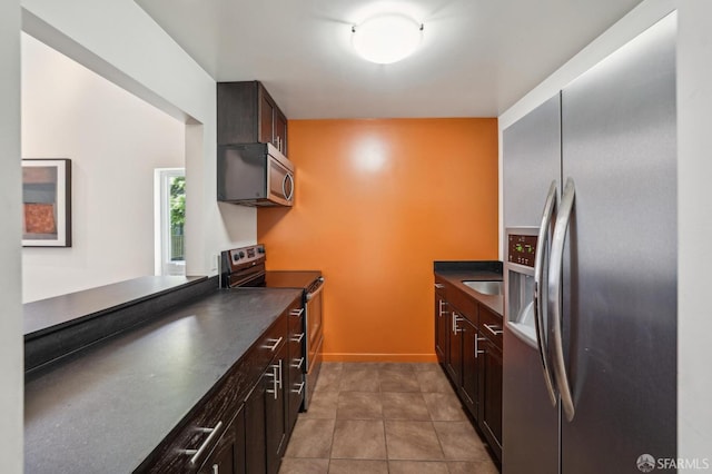620 Clarendon Ave, San Francisco, CA 94131 - kitchen featuring light tile patterned floors, dark countertops, appliances with stainless steel finishes, and baseboards