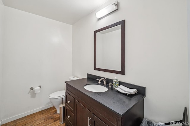 620 Clarendon Ave, San Francisco, CA 94131 - half bathroom featuring toilet, baseboards, wood finished floors, and vanity