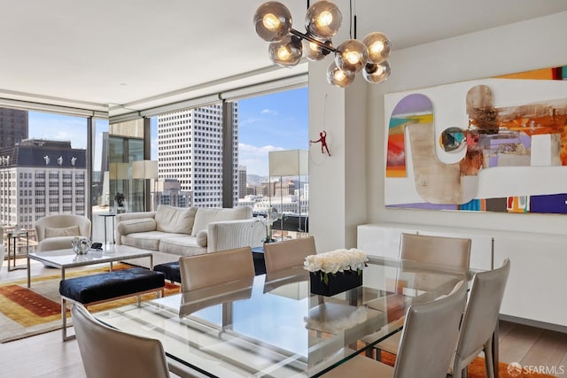 611 Washington St Unit 2505, San Francisco, CA 94111 - dining area with a view of city, wood finished floors, a chandelier, and a wall of windows